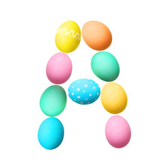 Letter A made of Easter eggs on light background