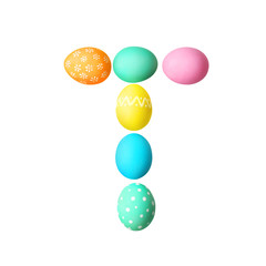 Letter T made of Easter eggs on light background