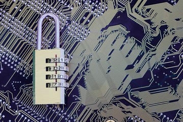 Padlock on a computer motherboard with the password 2017. The concept of cyber threats and cyber security.