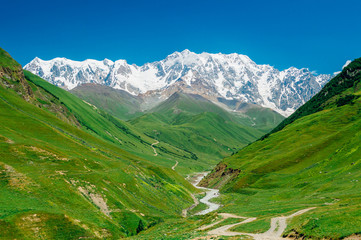 Rocky Caucasus Mountains (Bezengi Wall, Shkhara) with Enguri river landscape in Ushguli, Svaneti, Georgia  