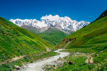 Fototapeta na wymiar Rocky Caucasus Mountains (Bezengi Wall, Shkhara) with Enguri river landscape in Ushguli, Svaneti, Georgia 
