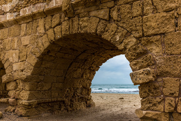 Spectacular view of the ruins of the Roman aqueduct on the beach