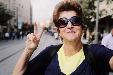 Portrait of cheerful senior woman enjoying the trip