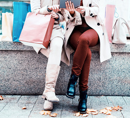 Beautiful women resting  near the fountain after shopping. Consu