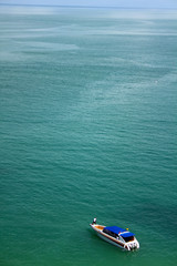 A lonely boat in the middle of the sea at Moo Kohi Ang Thong National Marine Park, Thailand. Top view