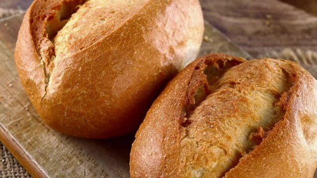 Portion of fresh baked Buns on a wooden plate (not loopable; 4K)