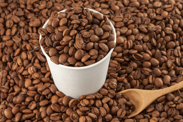 Coffee beans in a paper cup