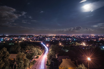 Light trail move you into a night city under moon light