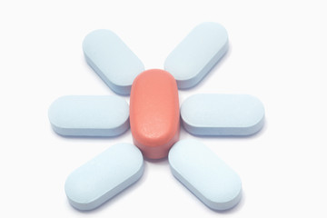 Macro shot of blue and red drugs on white background