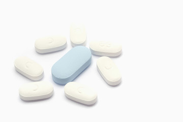 Macro shot of white and blue drugs on white background