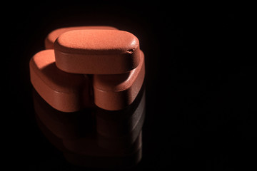 Macro shot of red drugs on black background