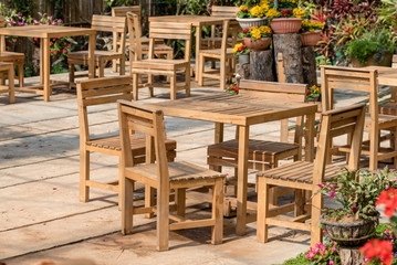 wooden table set in a flower garden