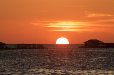 Naklejka na ściany i meble beautiful sunset with sun that goes down over the sea, Karimunja