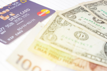 Credit cards and banknotes placed on the book