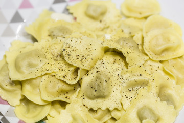 Italian Pasta cooked served with black spices close up