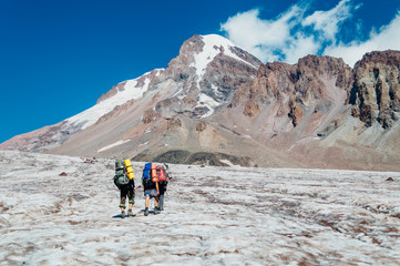 Fototapeta premium Hikers going to Mount Kazbek, Stepantsminda, Georgia