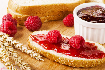 Raspberry jam with fresh raspberry and bread
