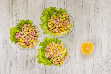 homemade fresh organic salad with white beans and avocado