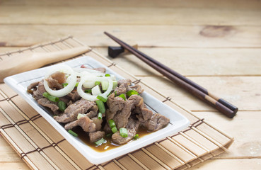 Sliced beef stir-fry Place the dish on a white square