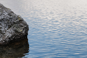 Minimalism rock in the ocean with copy space