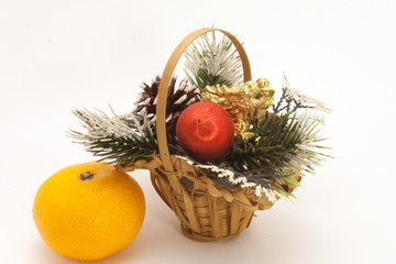 Christmas basket and one ripe tangerine isolated on white background
