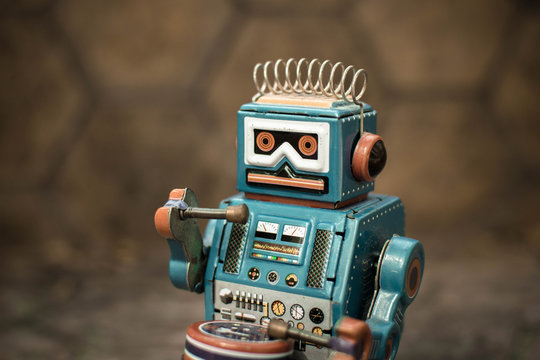 Old robot toy, vintage color style, vintage tone background.
