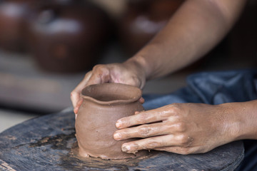 pottery making. hand transforming clay close up