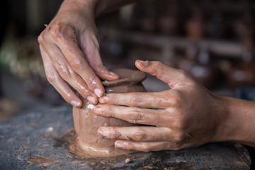 pottery making. hand transforming clay close up