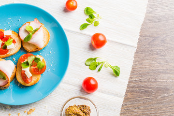 Bruschetta with tomato, cheese and bacon