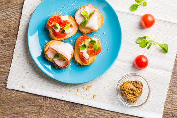 Bruschetta with tomato, cheese and bacon