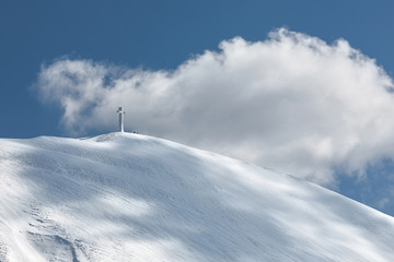 The cross of Mount Catria snow covered