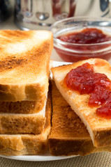 Toasted slices of bread with strawberry jam closeup