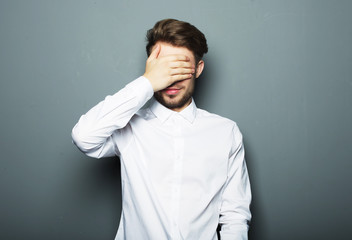 Sad businessman over grey background