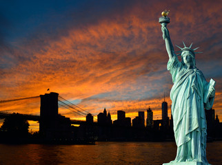 Statue of Liberty and Manhattan at sunset.