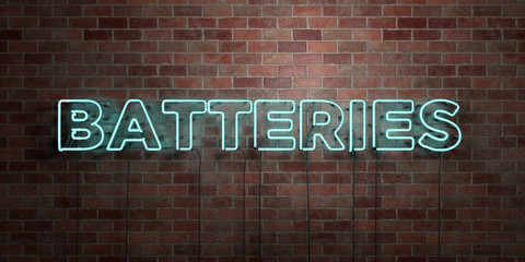 BATTERIES - fluorescent Neon tube Sign on brickwork - Front view - 3D rendered royalty free stock picture. Can be used for online banner ads and direct mailers..