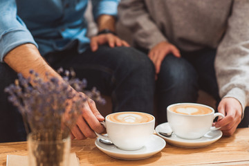 Lovers enjoying hot beverage on date