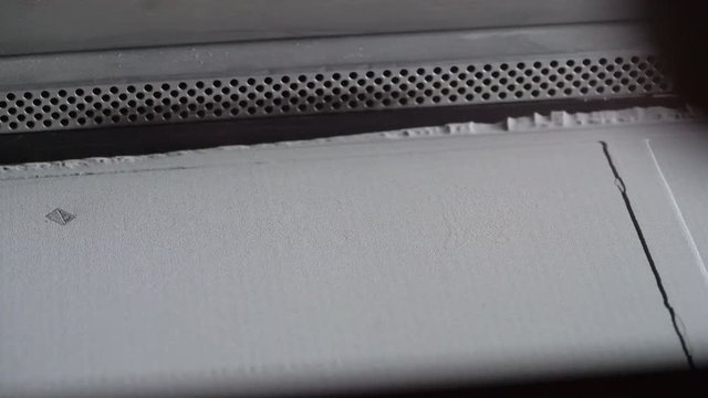 3D Printer during work. Selective laser sintering is an additive manufacturing technique that uses a laser as the power source to sinter powdered material.