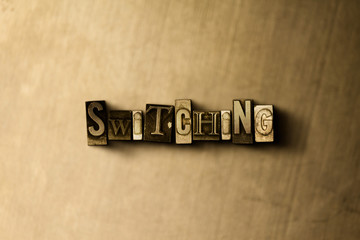 Obraz premium SWITCHING - close-up of grungy vintage typeset word on metal backdrop. Royalty free stock - 3D rendered stock image. Can be used for online banner ads and direct mail.