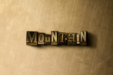 MOUNTAIN - close-up of grungy vintage typeset word on metal backdrop. Royalty free stock - 3D rendered stock image.  Can be used for online banner ads and direct mail.