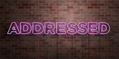 ADDRESSED - fluorescent Neon tube Sign on brickwork - Front view - 3D rendered royalty free stock picture. Can be used for online banner ads and direct mailers..