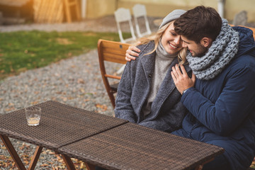 Fototapeta premium Joyful guy and girl hugging outdoors