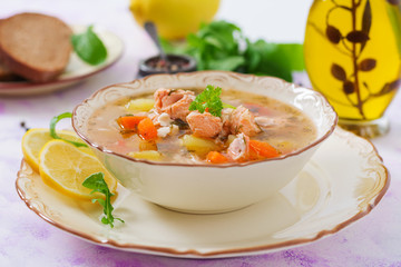 Salmon soup with vegetables in bowl