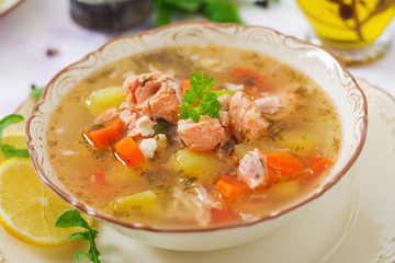 Salmon soup with vegetables in bowl