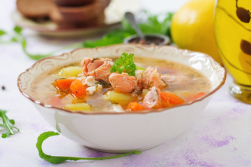 Salmon soup with vegetables in bowl