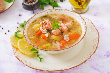 Salmon soup with vegetables in bowl