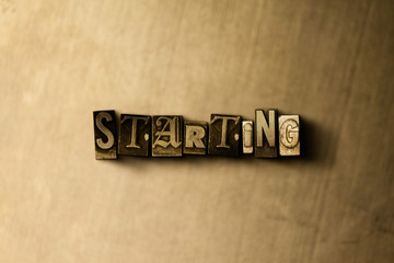 Obraz premium STARTING - close-up of grungy vintage typeset word on metal backdrop. Royalty free stock - 3D rendered stock image. Can be used for online banner ads and direct mail.