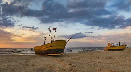 colorful fishing boats on the sea beach during sunset