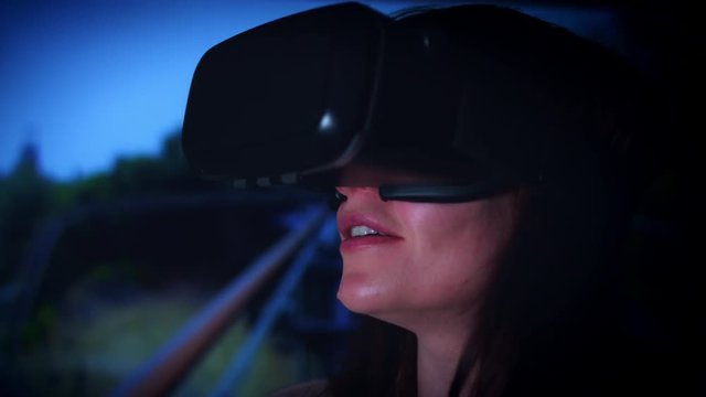4k Shot of a Woman with Virtual Reality Headset watching Rollercoaster Video
