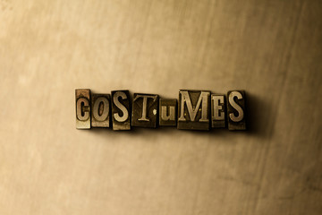 COSTUMES - close-up of grungy vintage typeset word on metal backdrop. Royalty free stock - 3D rendered stock image.  Can be used for online banner ads and direct mail.