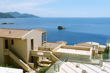 A view of the blue Ionian Sea, the mountains and stylish building